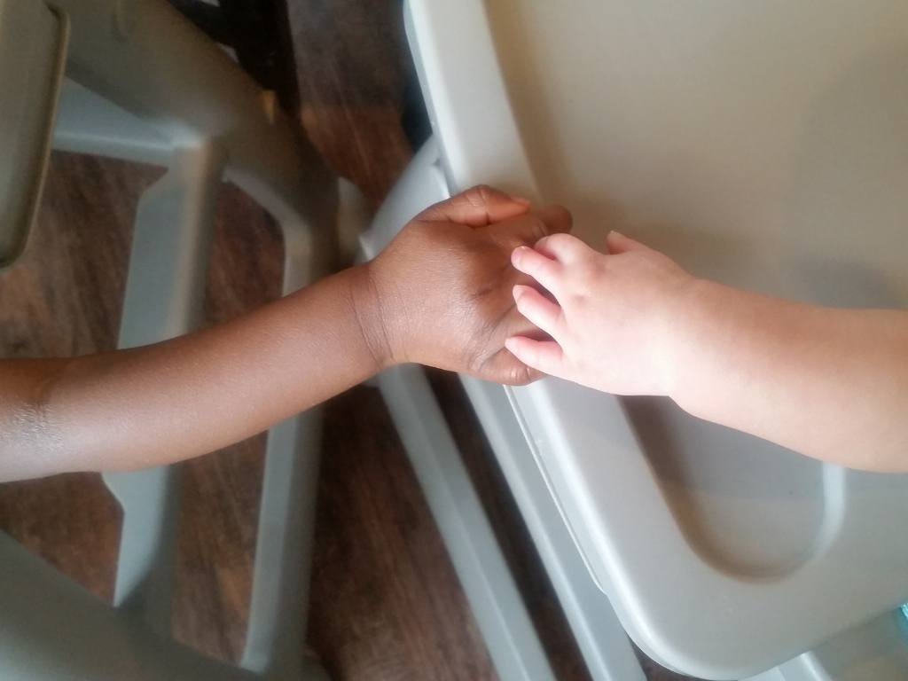 Hands of two children with special needs at Respite Care of San Antonio