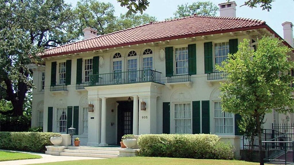 Davidson Respite House, a large white building with green shutters, manicured lawn and bushes