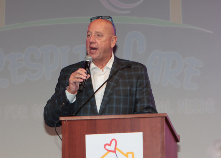 Auctioneer Tom T-Bone Bounds stood at the podium with a microphone