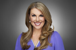 A professional headshot of Myra Arthur, smiling and wearing a purple blouse
